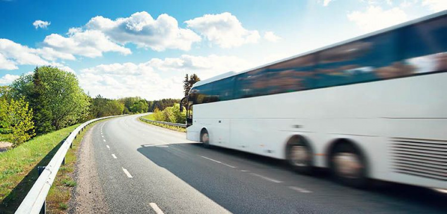 Bus on asphalt road in beautiful spring day