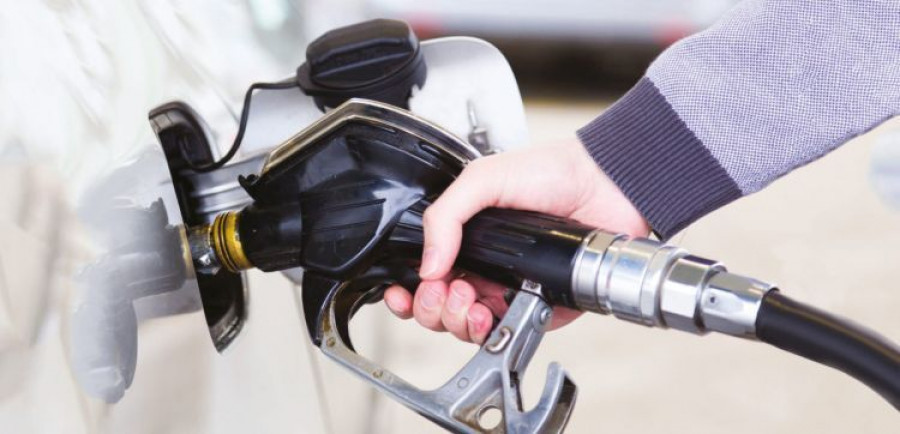 Petrol being pumped into a motor vehicle car.