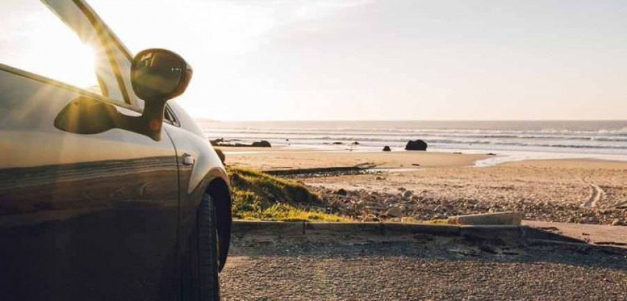 Car at beach at sunset