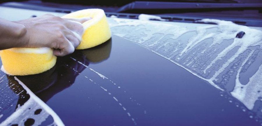hand hold sponge over the car for washing