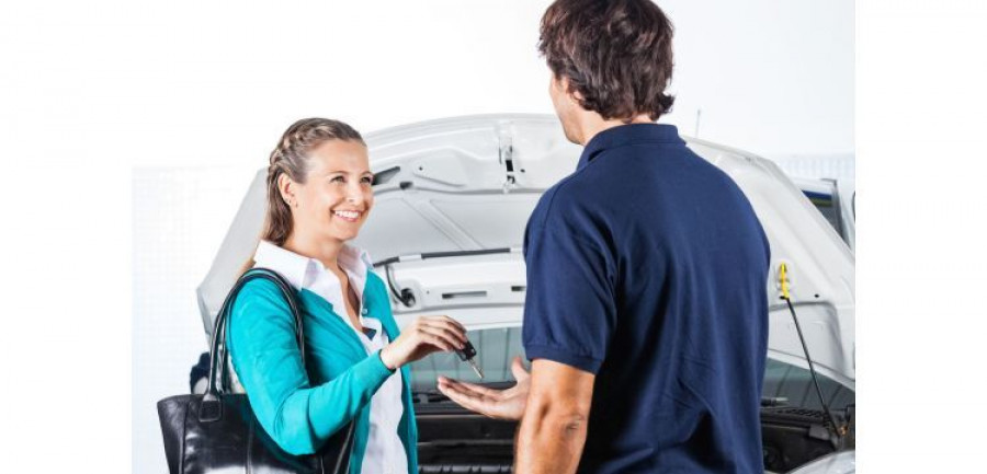Happy Client Giving Car Keys To Mechanic