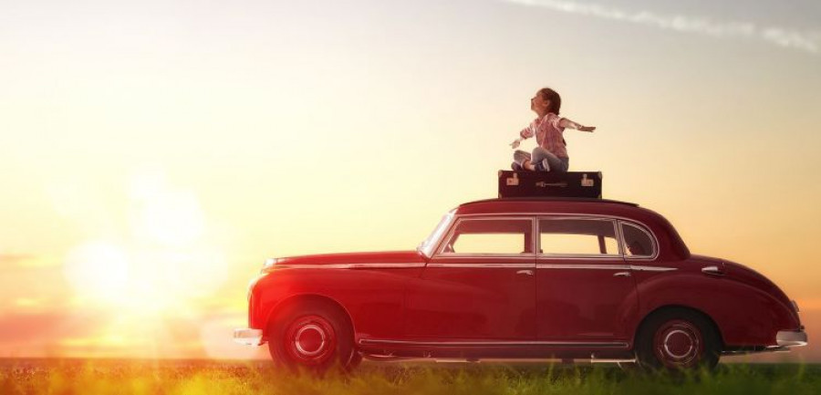 Toward adventure! Girl relaxing and enjoying road trip. Happy ch